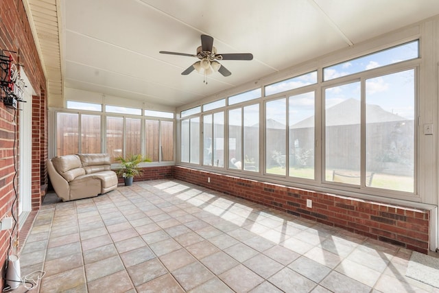 unfurnished sunroom featuring a healthy amount of sunlight and a ceiling fan