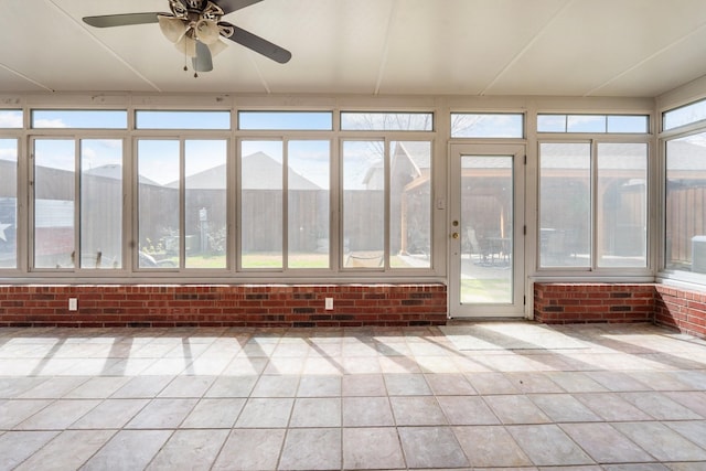 unfurnished sunroom with ceiling fan