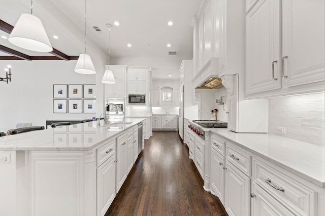 kitchen with premium range hood, dark wood finished floors, white cabinets, stainless steel appliances, and a sink