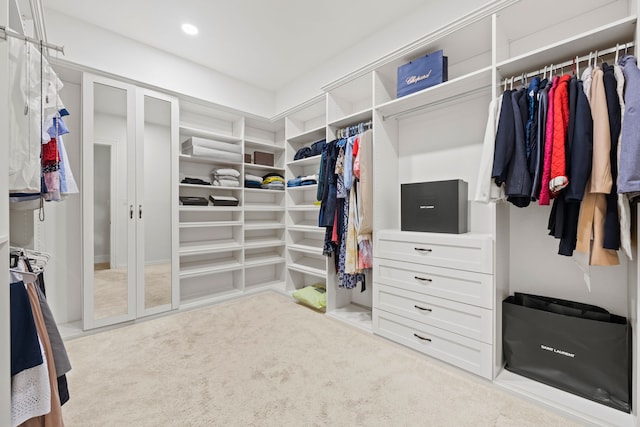 walk in closet with carpet flooring