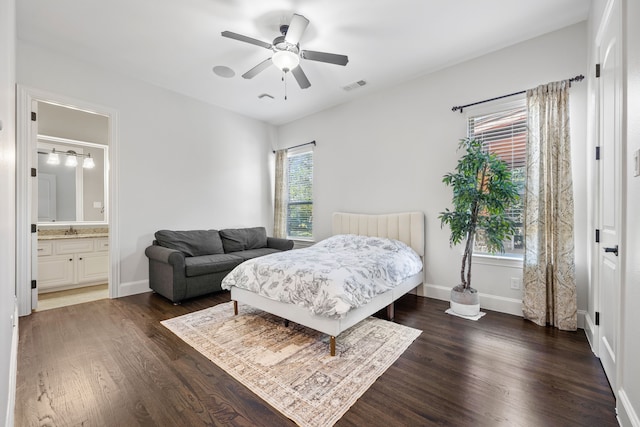 bedroom featuring visible vents, baseboards, and dark wood-type flooring