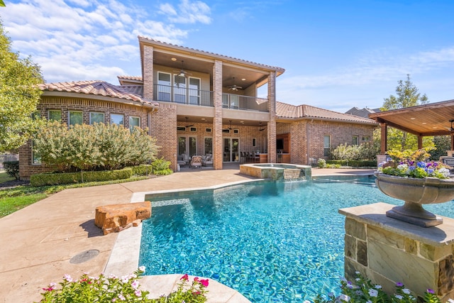 view of pool with a patio, a pool with connected hot tub, and ceiling fan