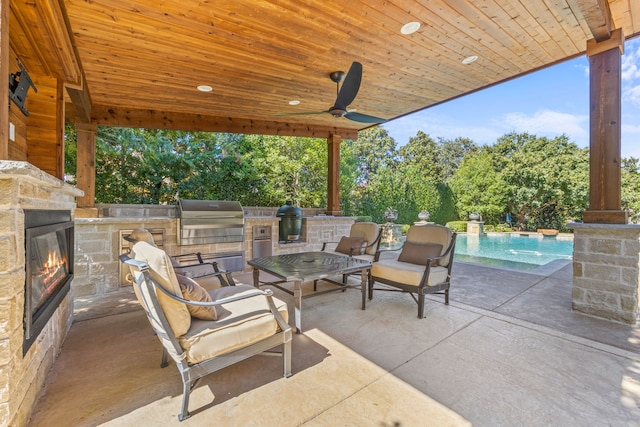 view of patio / terrace featuring area for grilling, an outdoor pool, and an outdoor stone fireplace