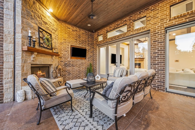 view of patio featuring an outdoor living space with a fireplace and french doors