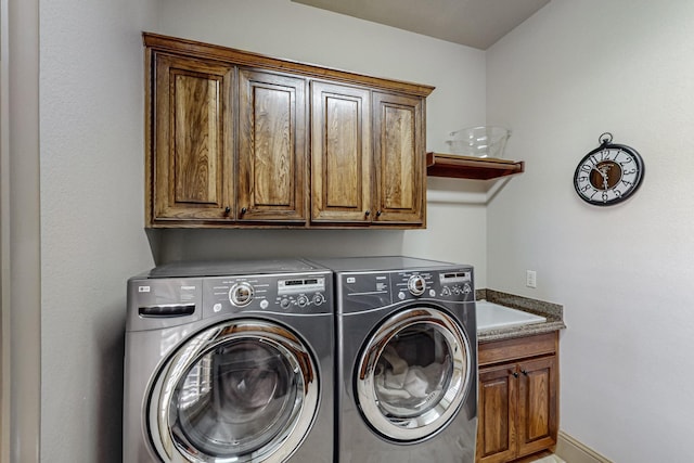 laundry area featuring cabinet space, independent washer and dryer, and baseboards