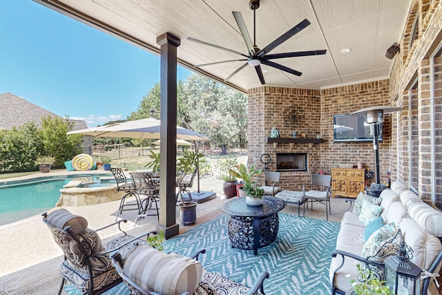 view of patio / terrace featuring an outdoor living space with a fireplace, a pool with connected hot tub, and ceiling fan