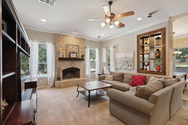 carpeted living room featuring visible vents, a stone fireplace, and ornamental molding