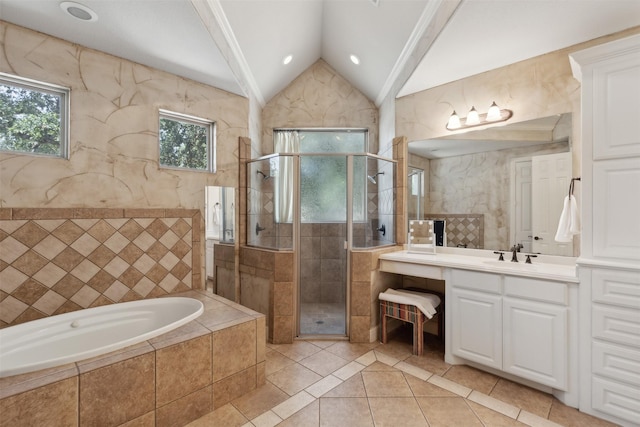 bathroom with a garden tub, a shower stall, tile patterned flooring, vanity, and vaulted ceiling