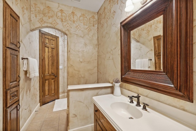 bathroom featuring wallpapered walls, vanity, visible vents, and tile patterned flooring