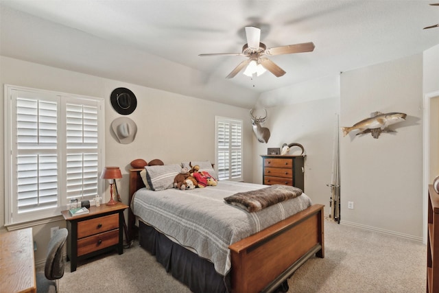 bedroom with ceiling fan, lofted ceiling, baseboards, and light carpet