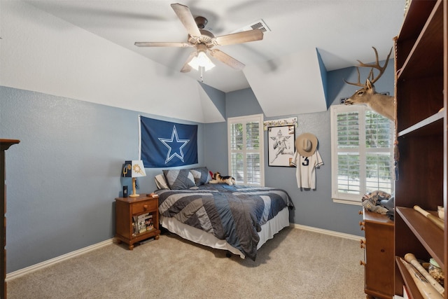 bedroom featuring baseboards, ceiling fan, carpet flooring, and vaulted ceiling