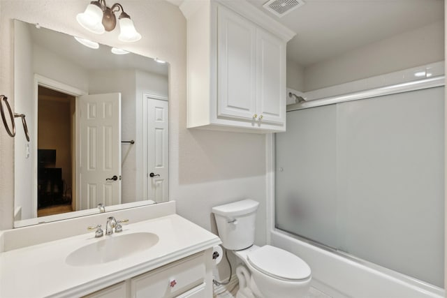 bathroom featuring visible vents, bath / shower combo with glass door, toilet, a notable chandelier, and vanity