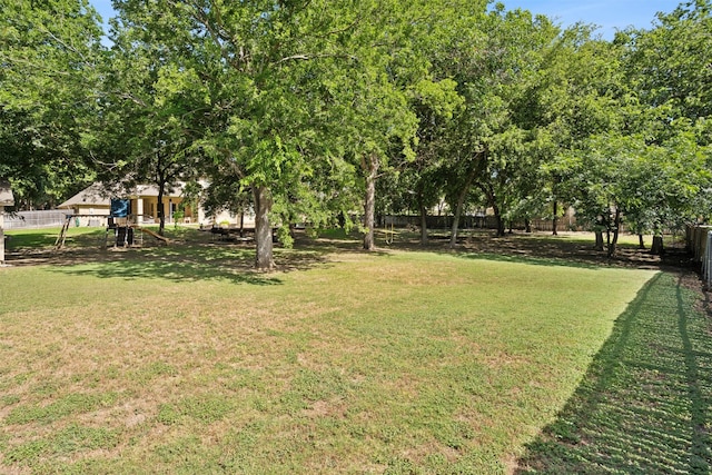 view of yard with a playground and fence