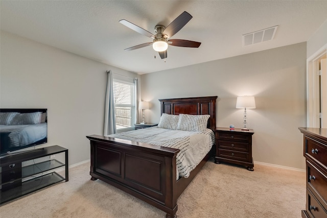 bedroom featuring visible vents, light colored carpet, and baseboards