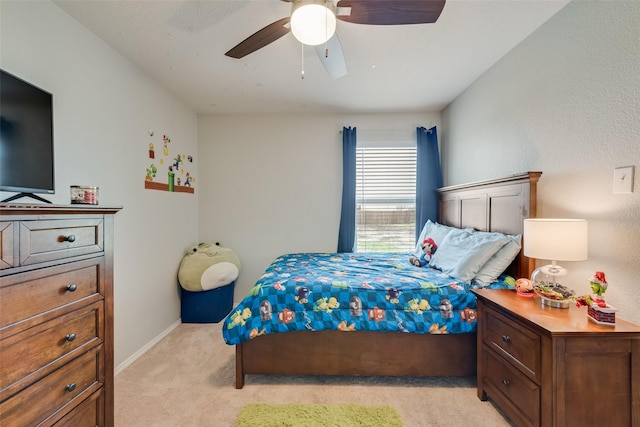 bedroom with baseboards, light colored carpet, and ceiling fan