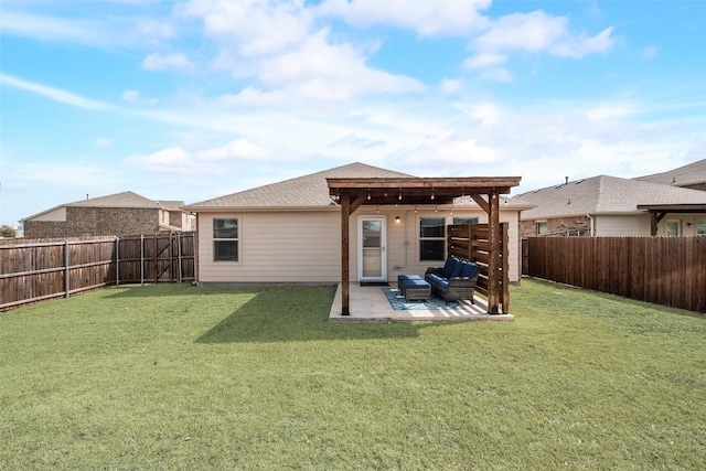 rear view of property featuring a yard, a patio area, a shingled roof, and a fenced backyard