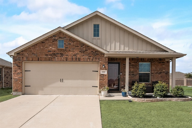 view of front of property with board and batten siding, a front yard, brick siding, and driveway