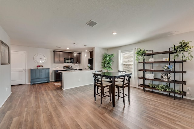 dining space featuring recessed lighting, wood finished floors, visible vents, and baseboards