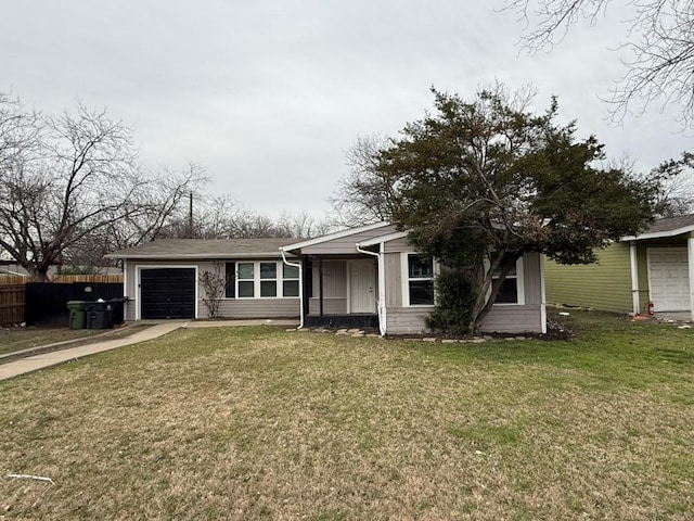 view of front of home with driveway, an attached garage, a front lawn, and fence