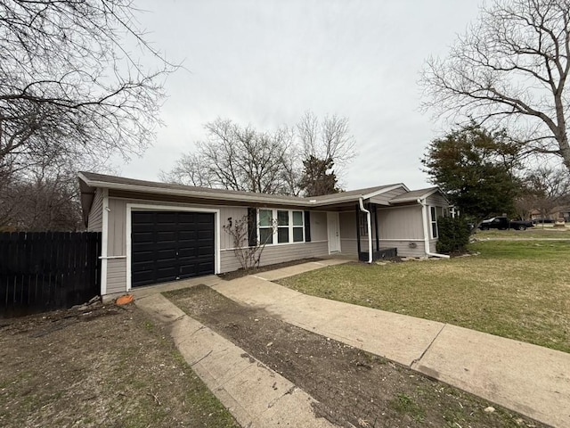 ranch-style home featuring a front lawn, fence, a garage, and driveway