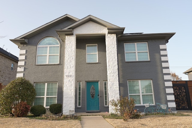 view of front of home featuring brick siding