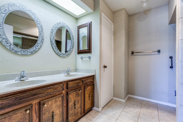 full bathroom with tile patterned floors, baseboards, and a sink