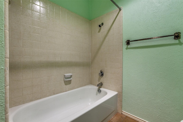 full bathroom with bathing tub / shower combination, a textured wall, and tile patterned floors