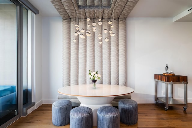dining space with wood finished floors and baseboards