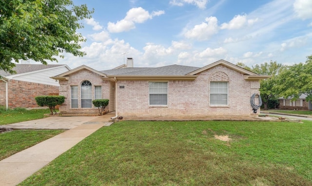 ranch-style house featuring a front lawn, brick siding, roof with shingles, and a chimney