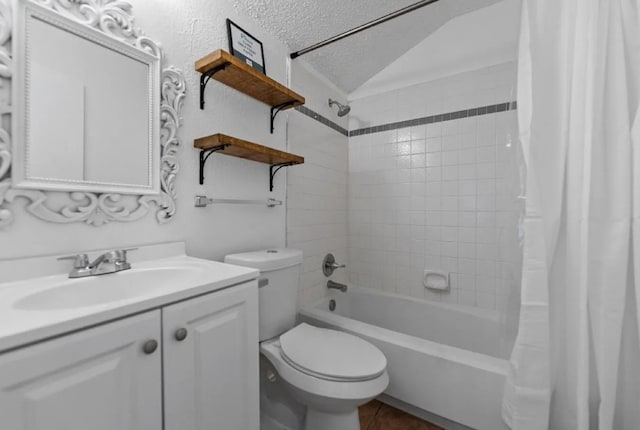 full bath featuring vanity, shower / bath combination with curtain, vaulted ceiling, a textured ceiling, and toilet