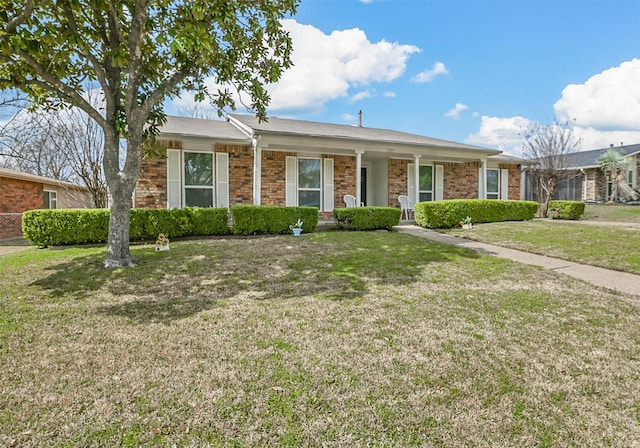 ranch-style house with brick siding and a front lawn