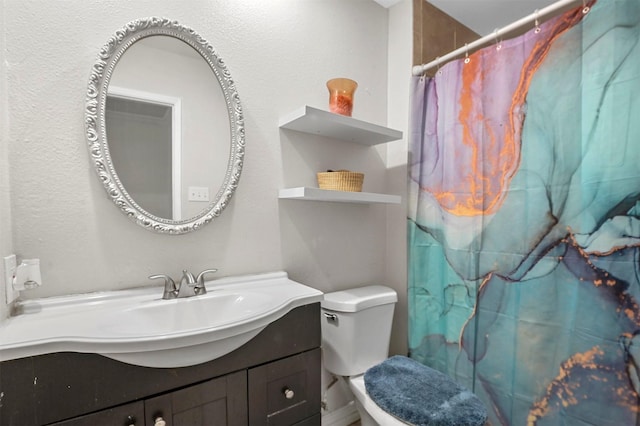 bathroom featuring toilet, vanity, and a shower with curtain