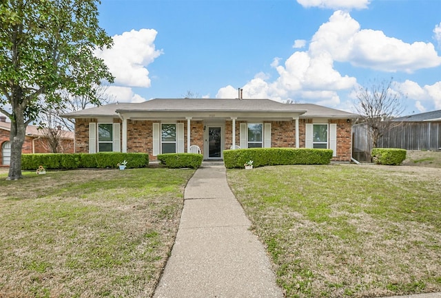 ranch-style house with brick siding and a front yard