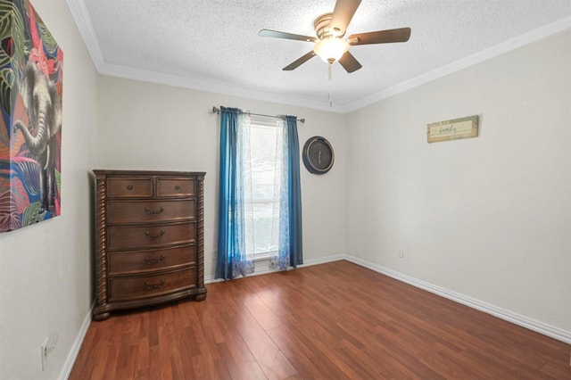 unfurnished room featuring ornamental molding, wood finished floors, and a textured ceiling