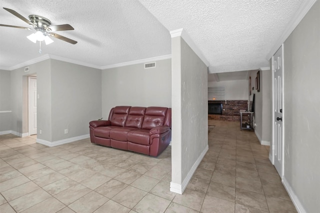 living area featuring visible vents, a ceiling fan, crown molding, light tile patterned floors, and baseboards