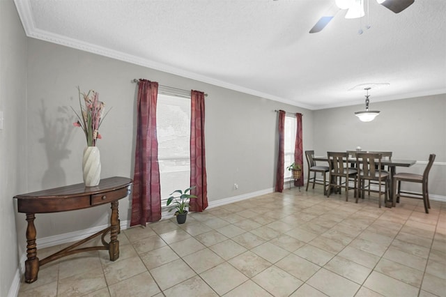 dining room with plenty of natural light, a textured ceiling, crown molding, and a ceiling fan