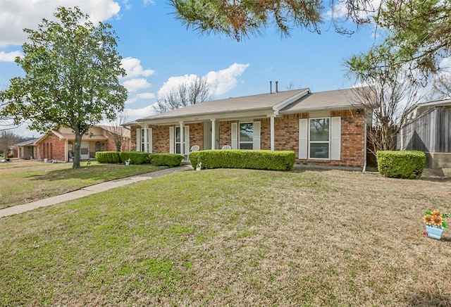 single story home featuring brick siding and a front yard