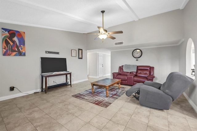 living room with visible vents, arched walkways, lofted ceiling, and baseboards