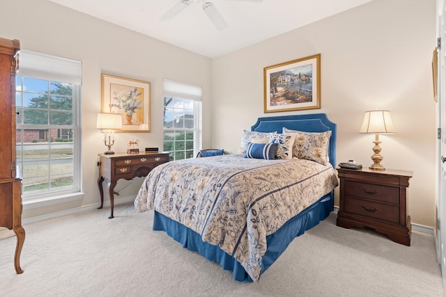 carpeted bedroom featuring multiple windows, baseboards, and ceiling fan