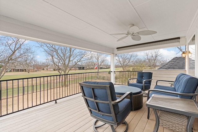 wooden deck with an outdoor hangout area and ceiling fan