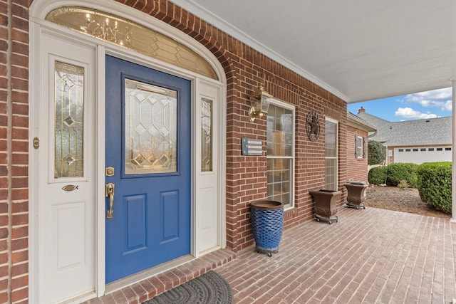 doorway to property with brick siding