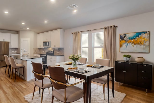 dining room with visible vents, recessed lighting, and light wood-style floors