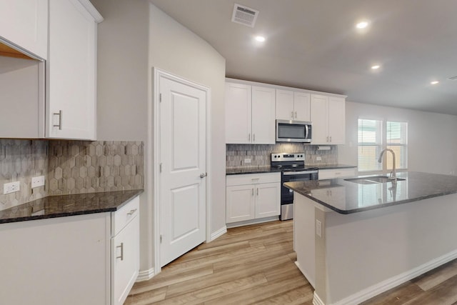 kitchen with light wood-style floors, visible vents, appliances with stainless steel finishes, and a sink