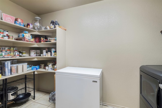 laundry area featuring light tile patterned flooring, laundry area, and separate washer and dryer