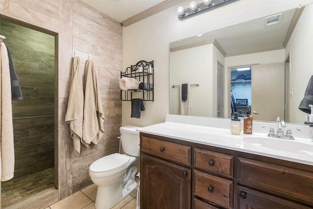 bathroom with vanity, visible vents, tiled shower, tile patterned flooring, and toilet