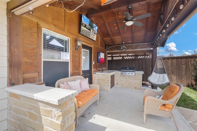 view of patio / terrace featuring area for grilling, a ceiling fan, a sink, fence, and a grill