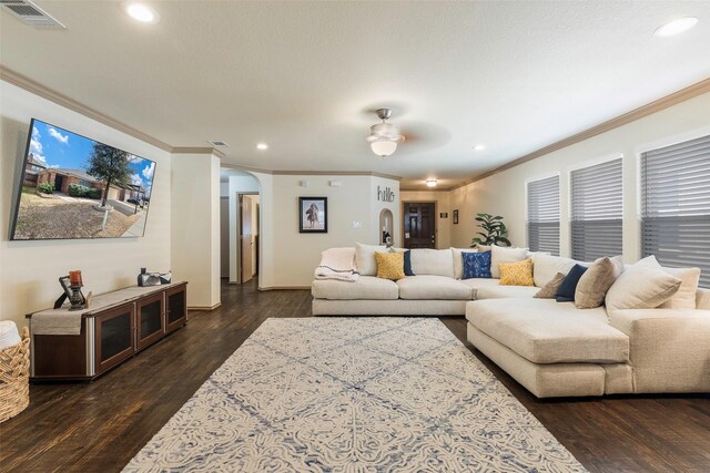 living area featuring recessed lighting, visible vents, arched walkways, and dark wood-style flooring