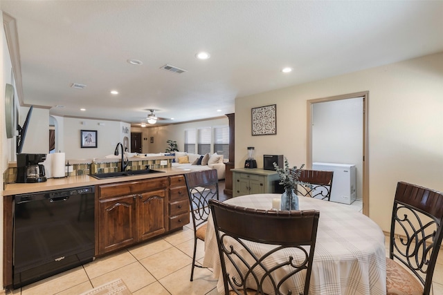 kitchen with visible vents, light countertops, black dishwasher, light tile patterned floors, and a sink