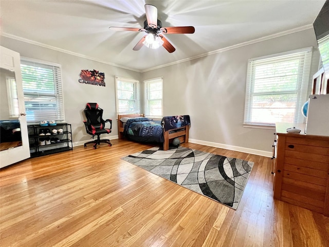 bedroom featuring baseboards, wood finished floors, and crown molding