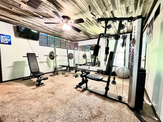 exercise room with wooden ceiling, carpet flooring, baseboards, and ceiling fan